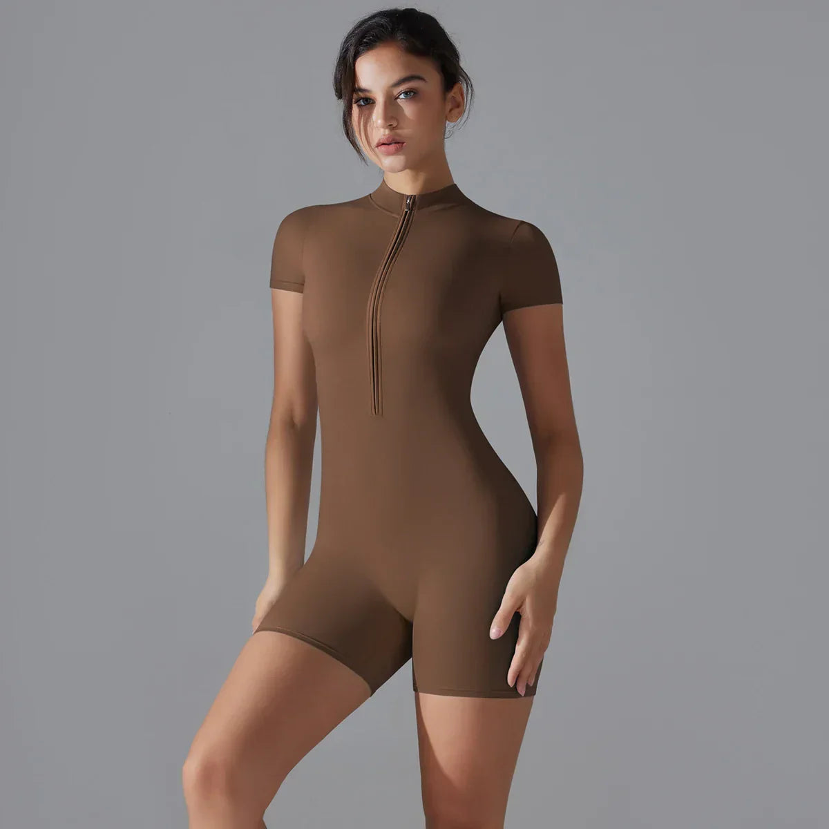 Zipper Front Workout Bodysuit in brown, showcasing sleek design and body-hugging fit for versatile activities.