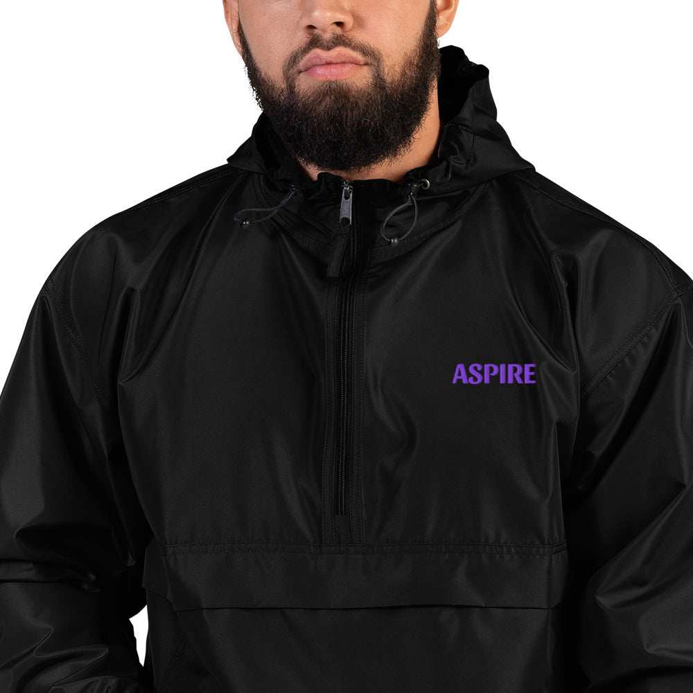 Embroidered Champion Packable Jacket in black polyester with a hood, front zipper, and small purple chest embroidery reading Aspire.
