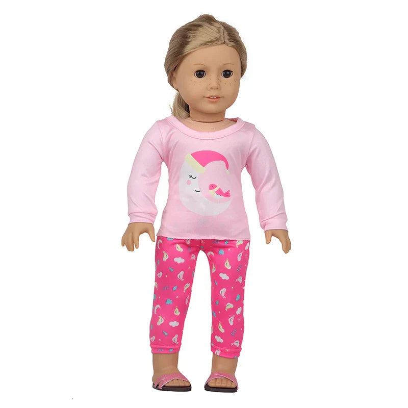 Soft Doll Pajama Set on doll with pink top and patterned pants.