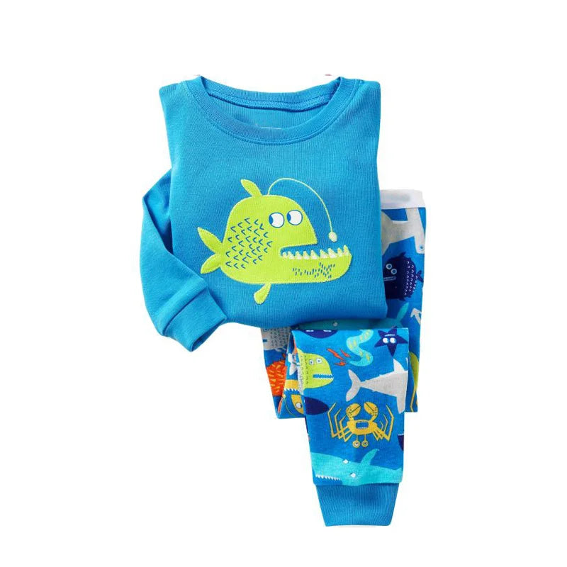 Kids Animal Pajama Set in bright turquoise cotton knit, featuring a lime-green cartoon fish top and blue animal-print pants.