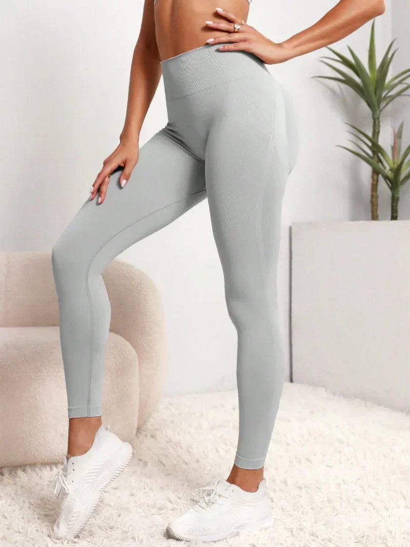 High Waist Stretchy Yoga Pants in light gray stretch fabric, with a high-rise waistband, smooth finish, and fitted legs.