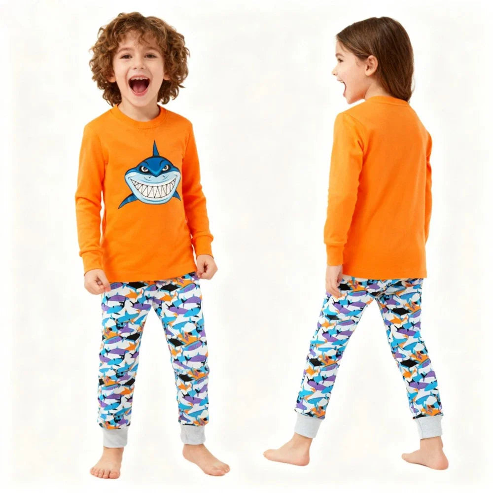 Kids Animal Pajama Set in bright orange cotton knit, with a grinning shark graphic, colorful shark-print pants and gray cuffs.