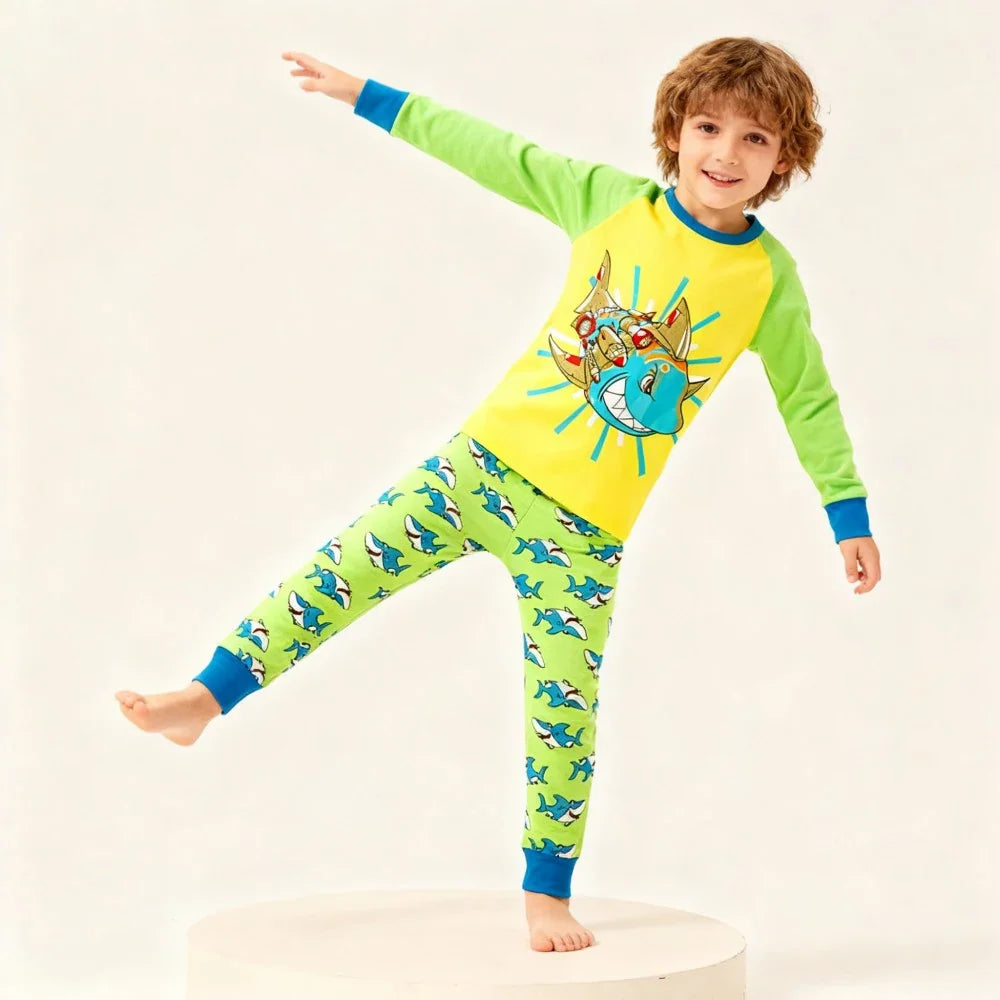 Kids Animal Pajama Set in bright yellow and lime-green cotton knit, featuring a cartoon shark top and matching shark-print pants.