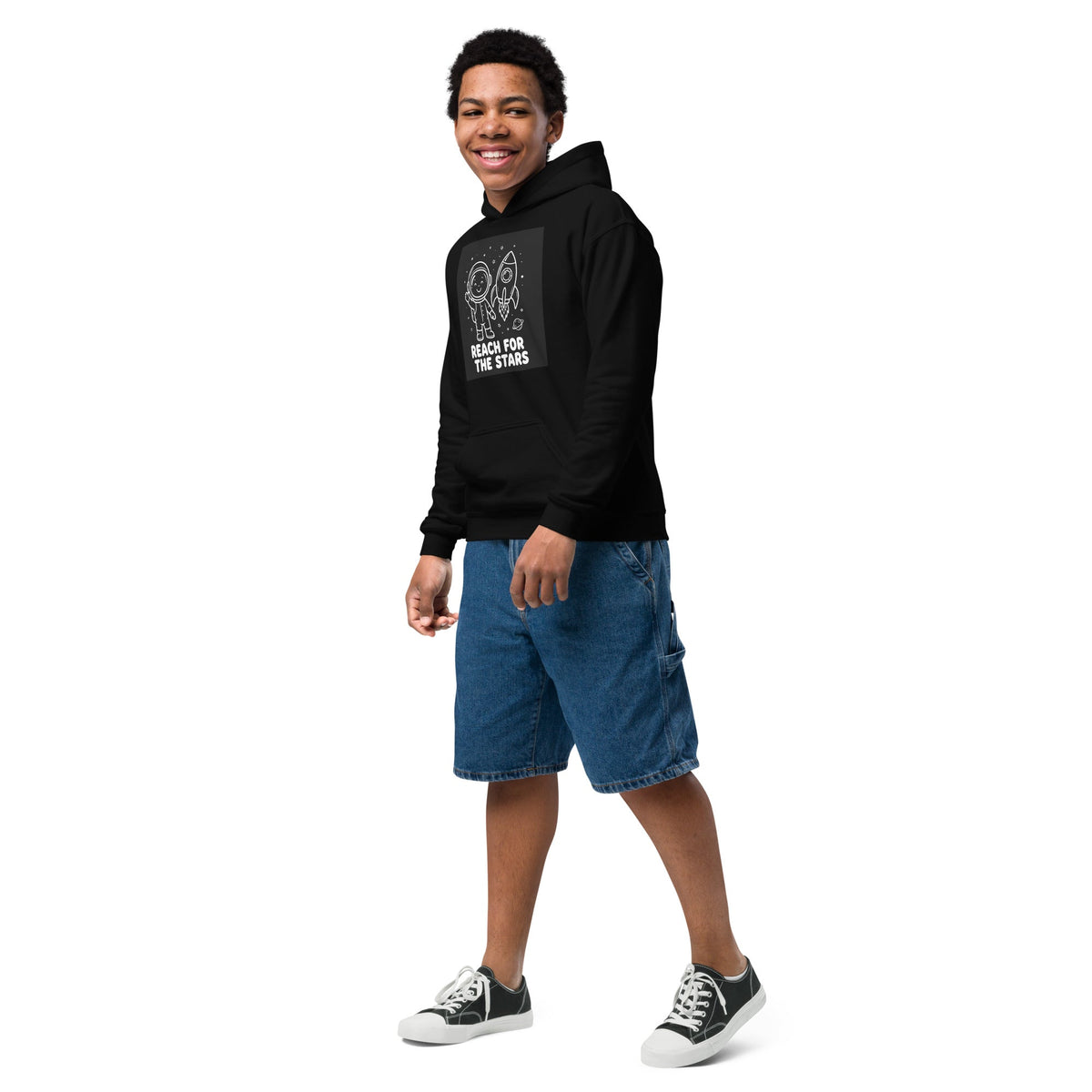 Youth hoodie in black cotton-polyester fleece, featuring a white rocket and space-themed Reach for the Stars chest print and pouch pocket.